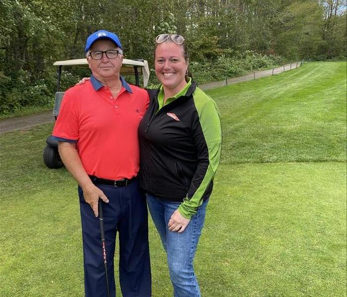 SERVPRO of Barrie Project Manager Kayla Guy and industry professional John Ross posing on the golf course.